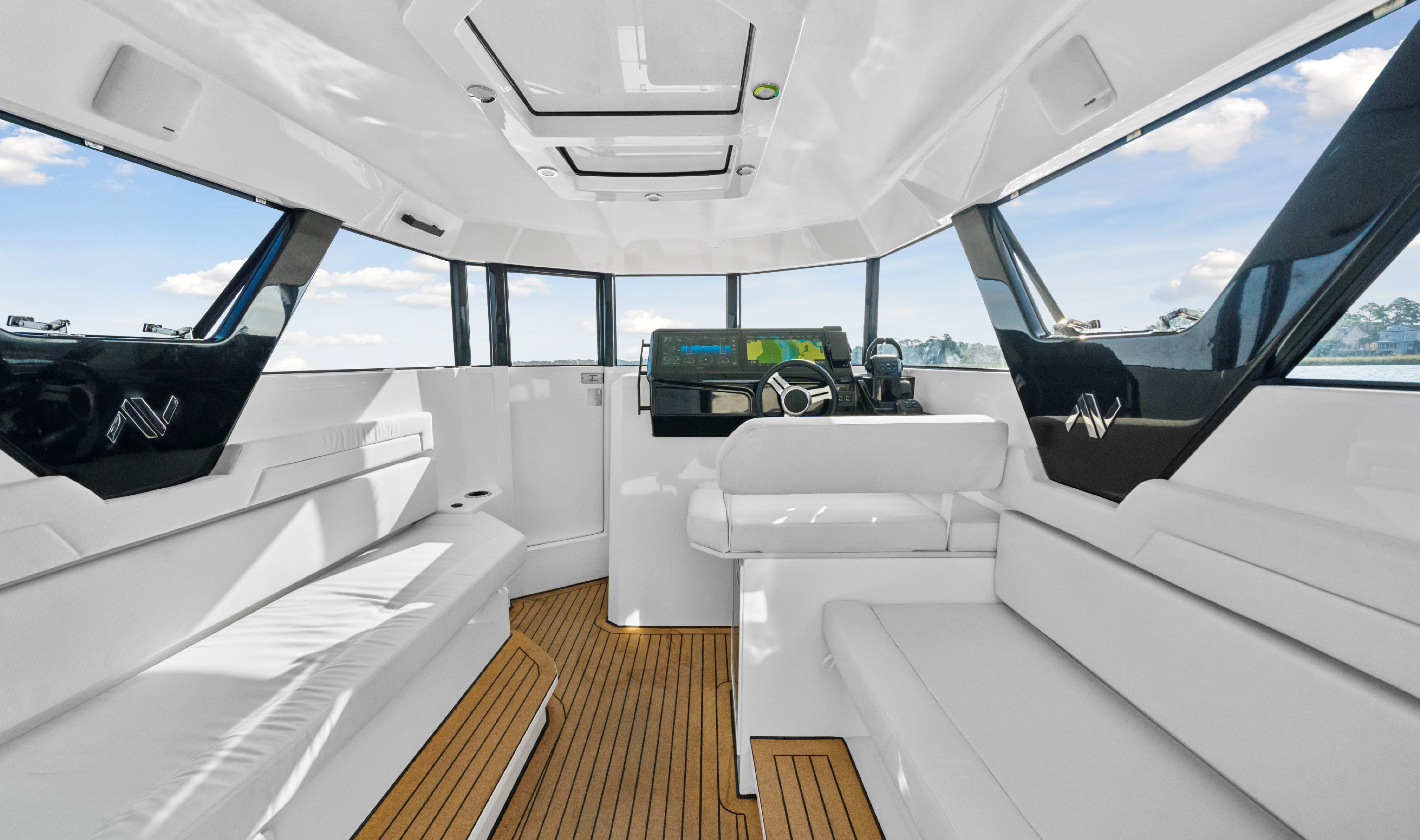 Bright interior cabin of the Navier N30 looking forward towards the helm